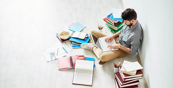 student sitting on the floor studying