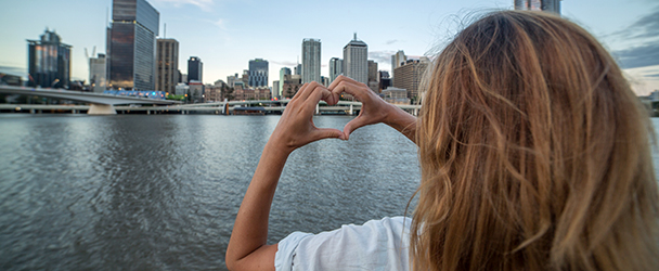 student on the Brisbane river, looking at the Brisbane CBD