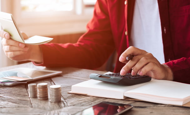 student budgeting on a calculator
